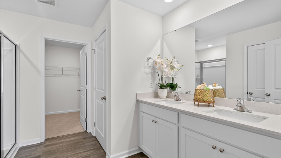 Primary bathroom with double sink and walk-in shower