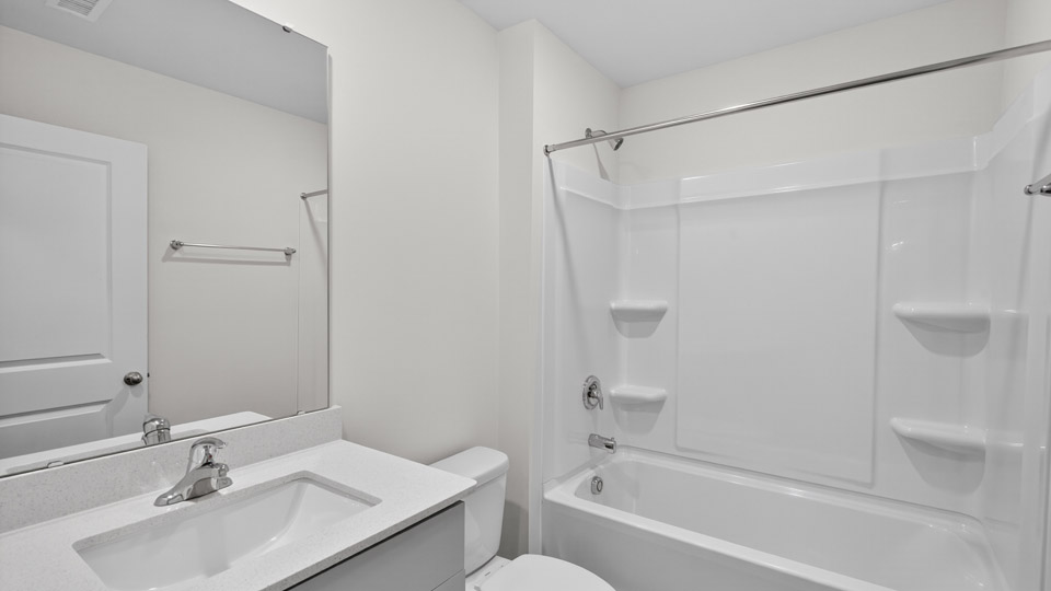 secondary bathroom with shower tub combo and single vanity sink