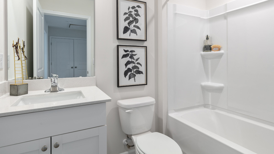 secondary bathroom with shower tub combo and single vanity sink