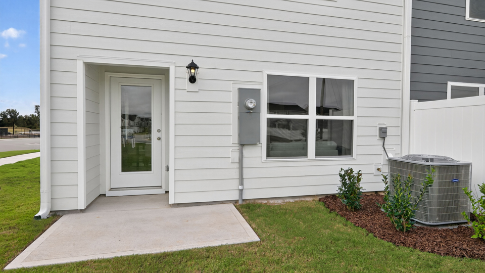 exterior patio with concrete slab and open yard