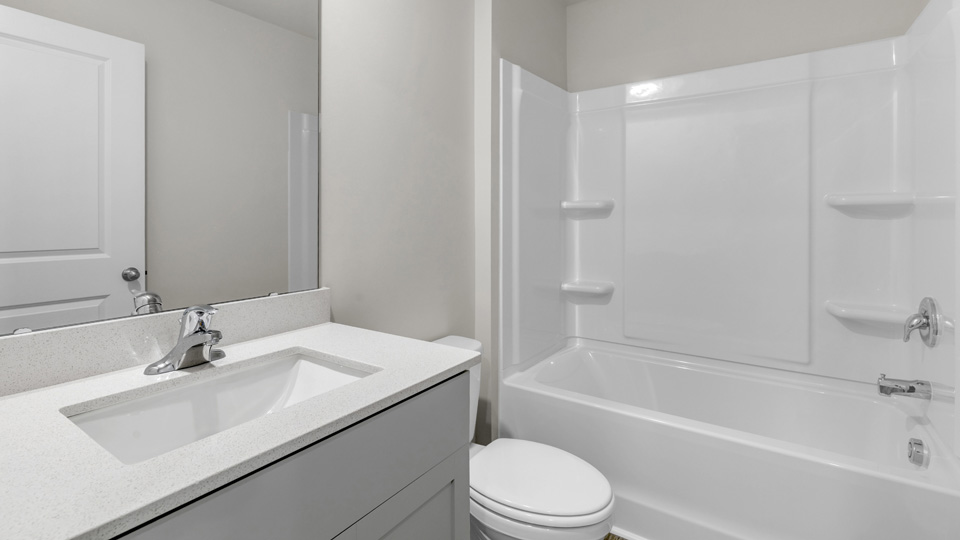 bathroom with white cabinets