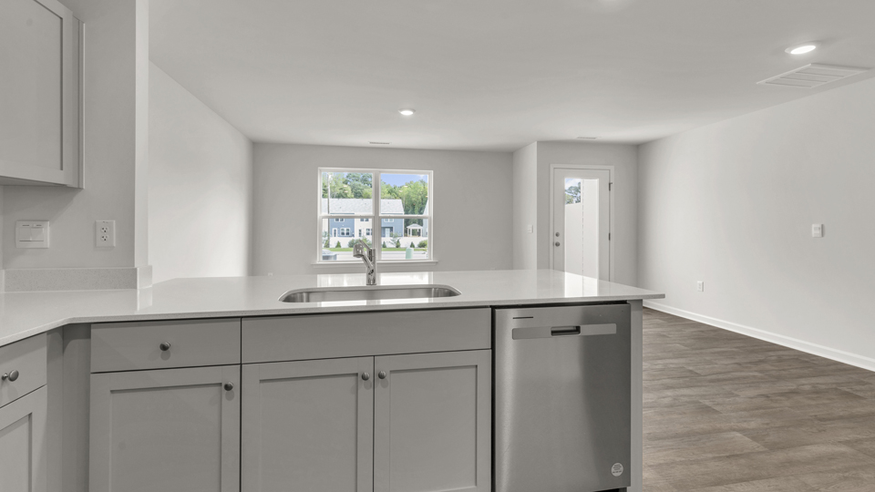 kitchen with quartz counters, kitchen peninsula,  pantry, stainless steel appliances