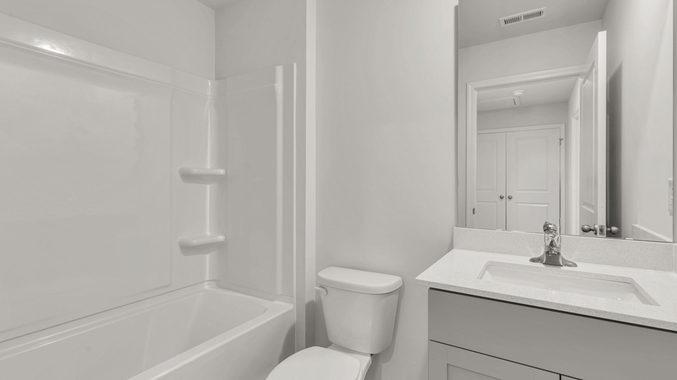 secondary bathroom with shower tub combo and single vanity sink