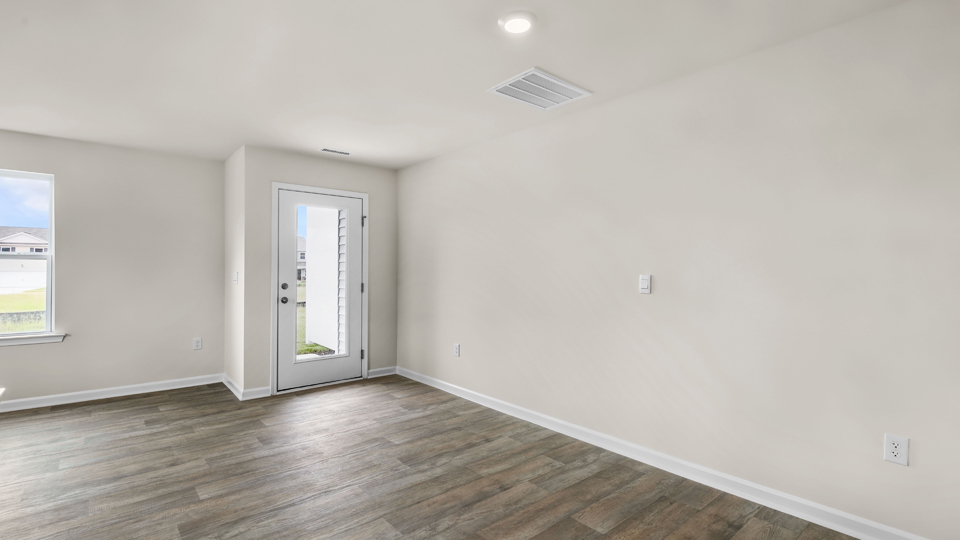 open concept dining space with door to patio