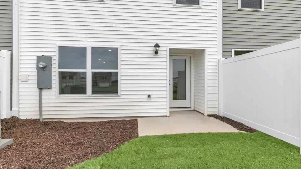 exterior patio with concrete slab and open yard