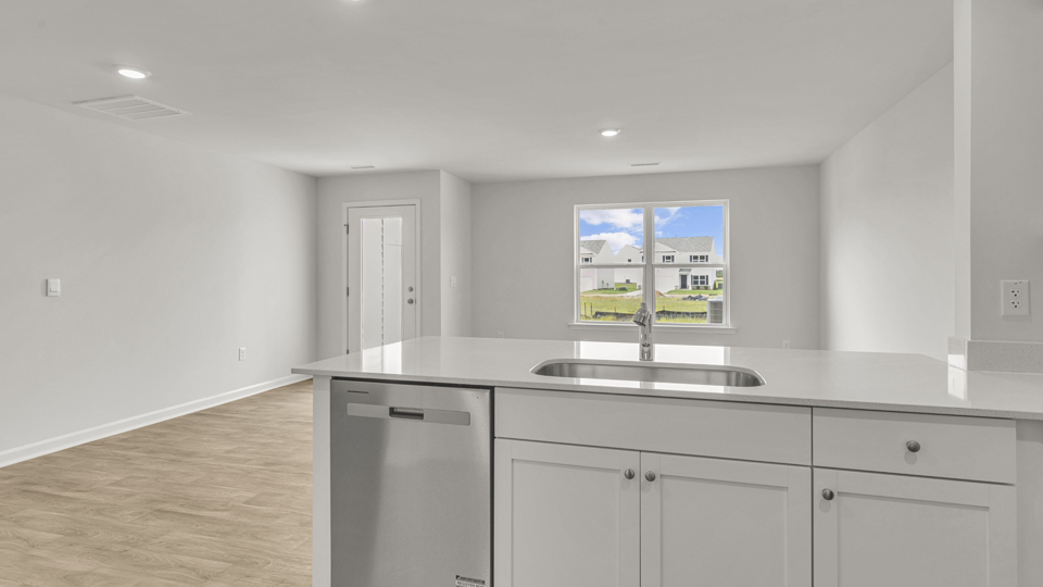 kitchen with quartz counters, kitchen peninsula,  pantry, stainless steel appliances