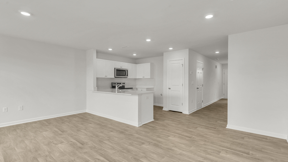 kitchen with quartz counters, kitchen peninsula,  pantry, stainless steel appliances