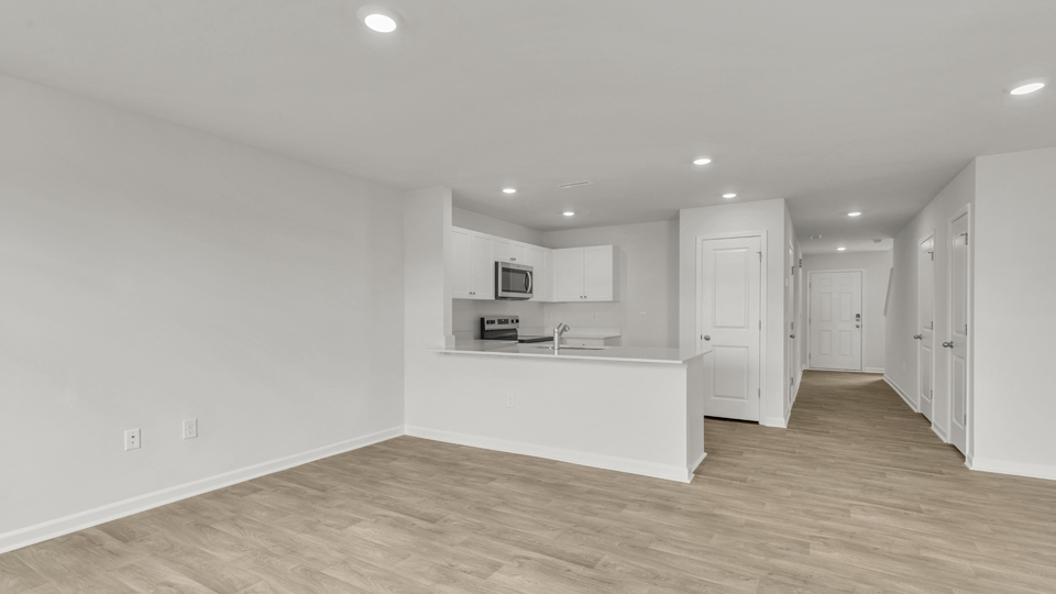 kitchen with quartz counters, kitchen peninsula,  pantry, stainless steel appliances