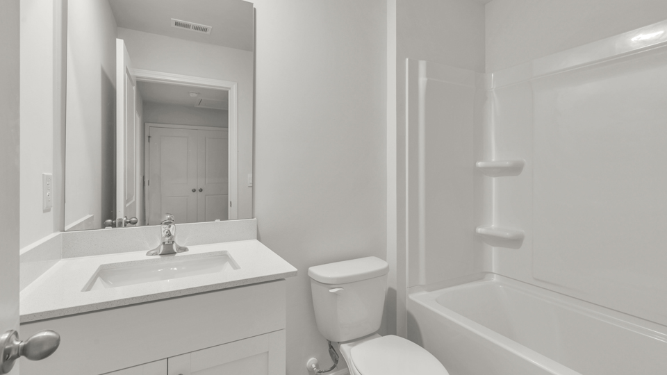 secondary bathroom with shower tub combo and single vanity sink