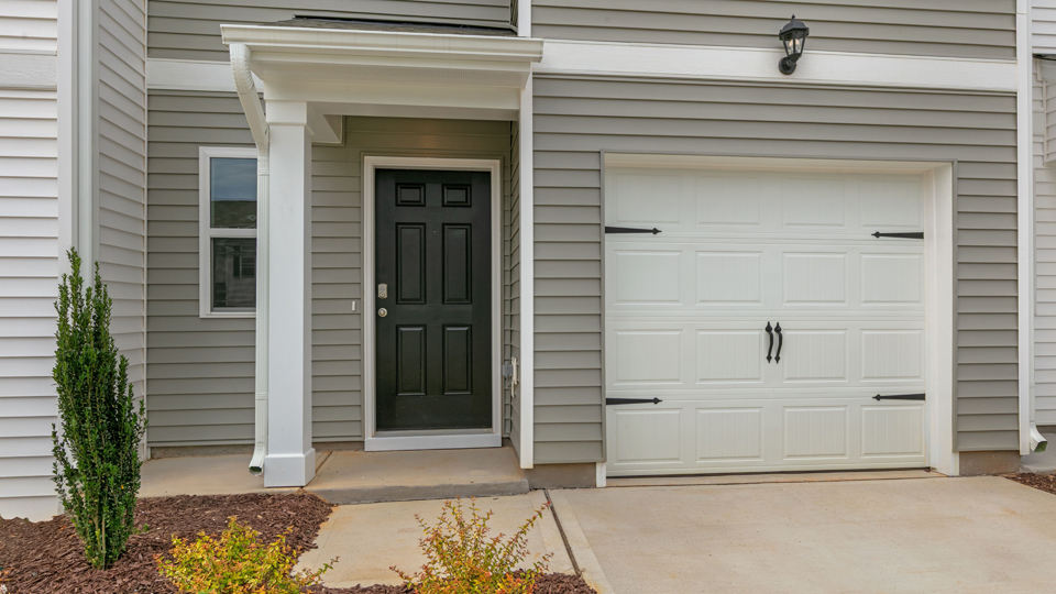 front door, grey, and single-car garage door, white
