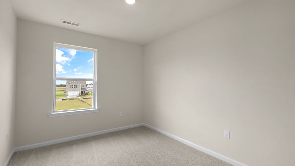secondary bedroom with window and closet, carpeting