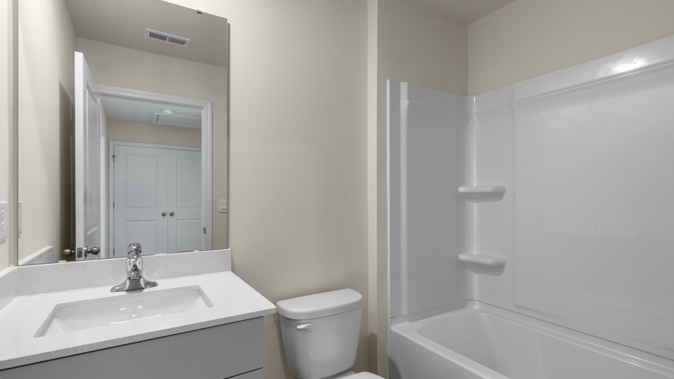 secondary bathroom with shower tub combo and single vanity sink