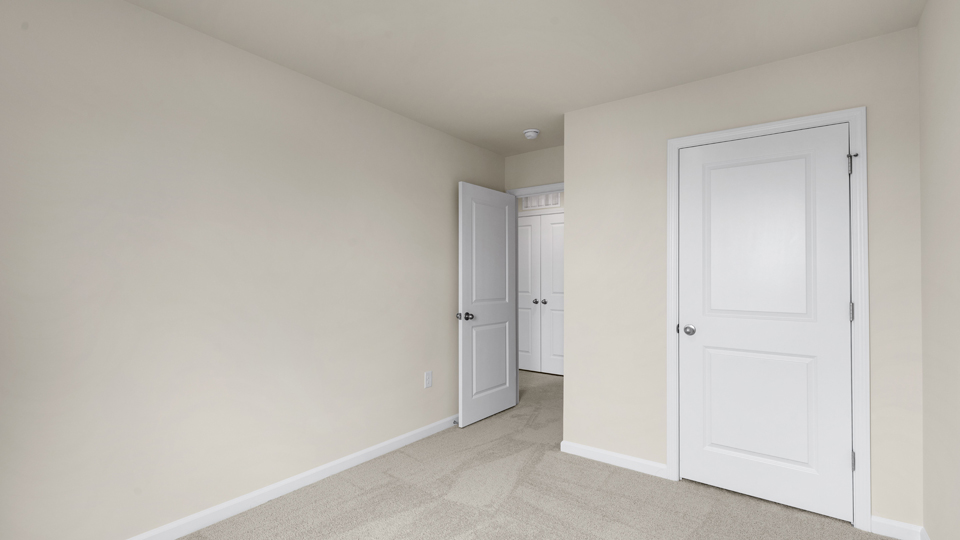 additional bedroom with window, carpeting, closet