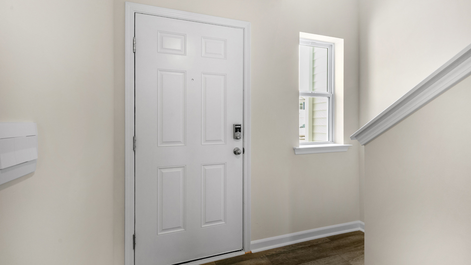 entry way featuring the front door and stairs