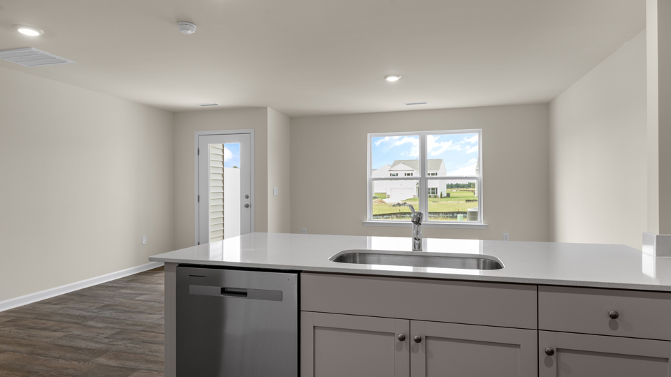 open floorplan kitchen with quartz counters,pantry, stainless steel appliances