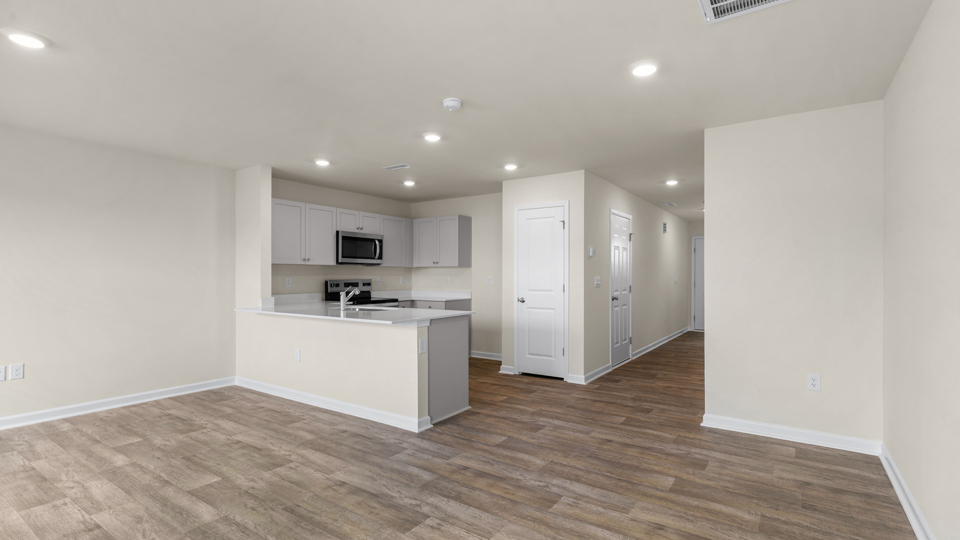 open floorplan kitchen with quartz counters,pantry, stainless steel appliances
