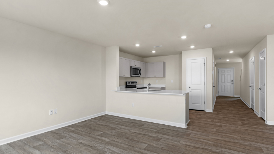 open floorplan kitchen with quartz counters,pantry, stainless steel appliances