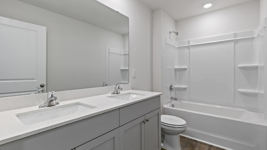 secondary bathroom with single vanity sink and shower tub combo