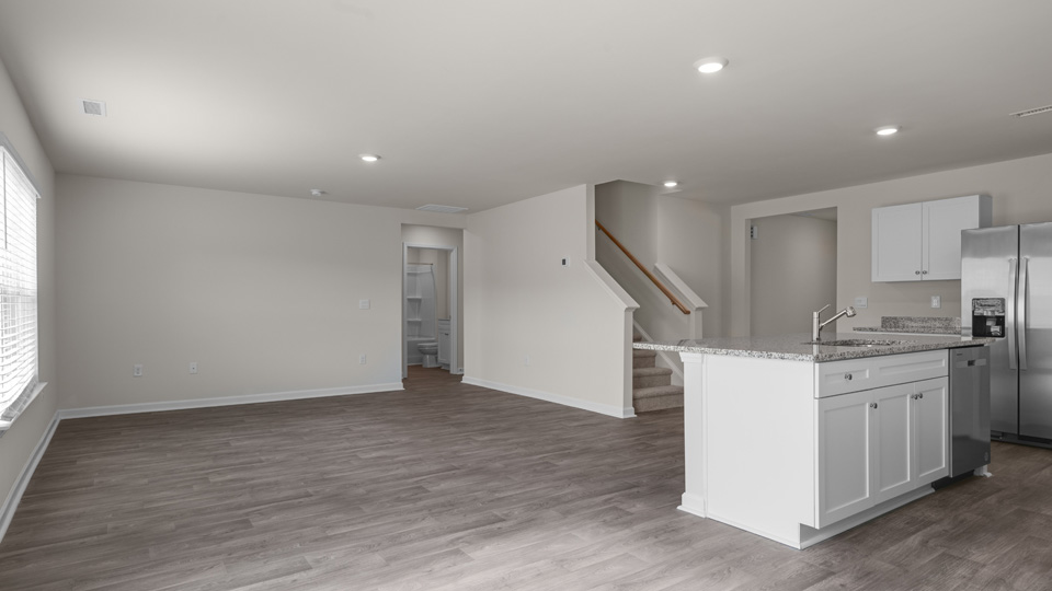 kitchen island, stairwell, and living space
