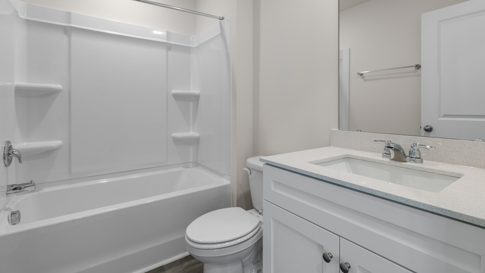secondary bathroom with shower tub combo and single vanity sink