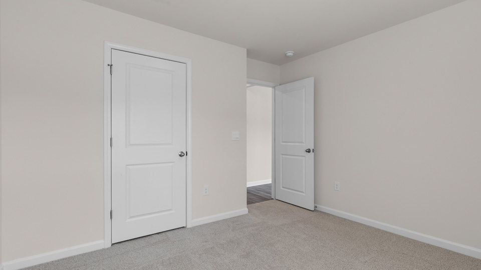 secondary bedroom with closet and carpeting