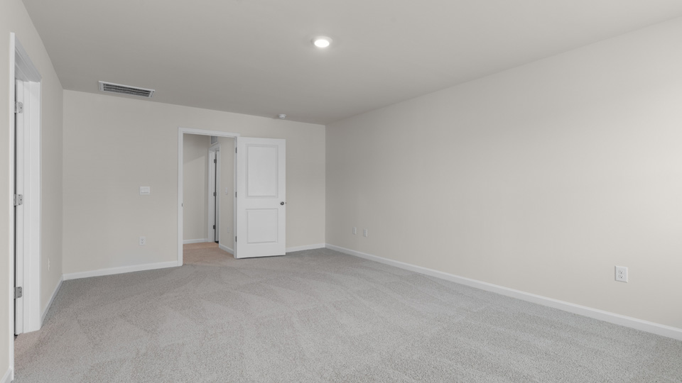 primary bedroom with carpeting