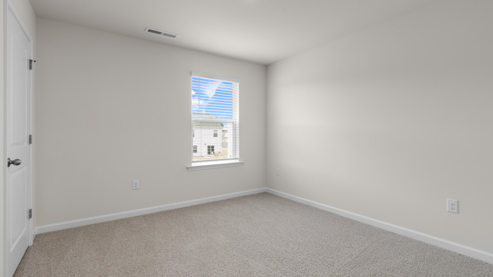third bedroom with window and carpeting