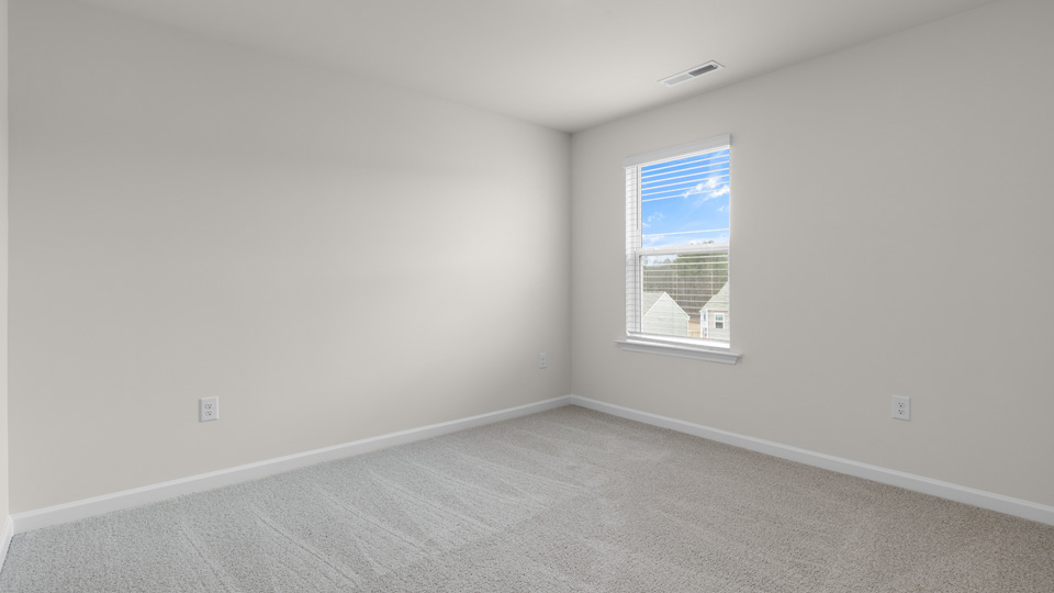 fourth bedroom with window and carpeting