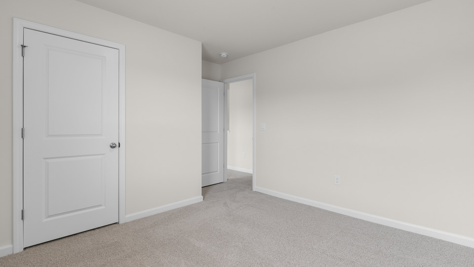 fifth bedroom with closet and carpeting