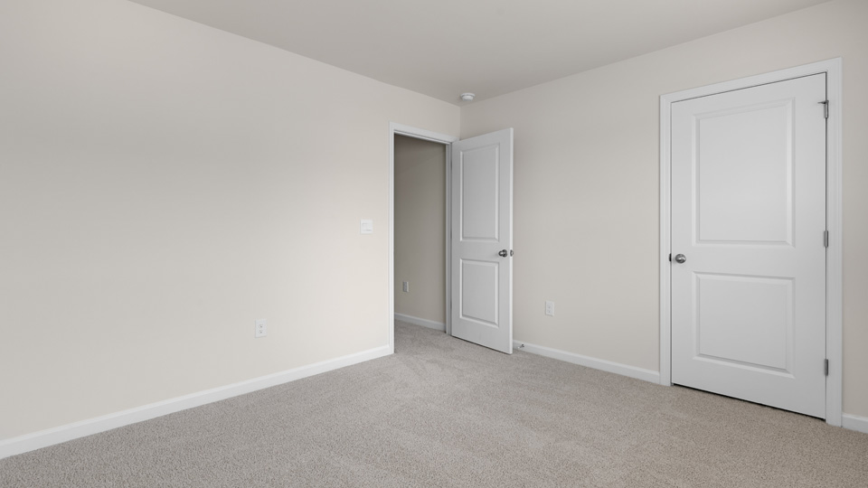 fifth bedroom with closet and carpeting