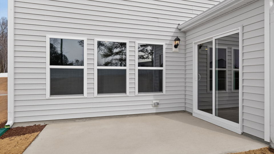 exterior patio with concrete slab and open yard