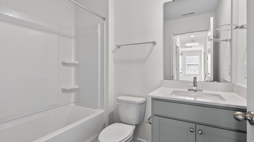 secondary bathroom with shower tub combo and single vanity sink
