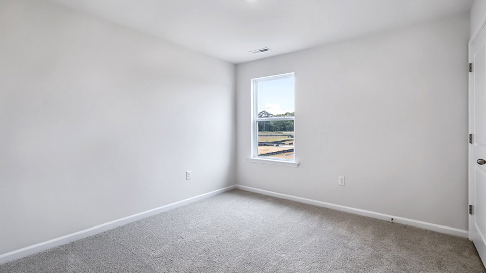 additional bedroom with window, carpeting, closet