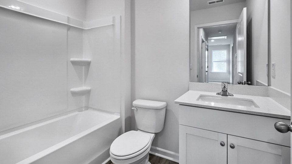 secondary bathroom with shower tub combo and single vanity sink