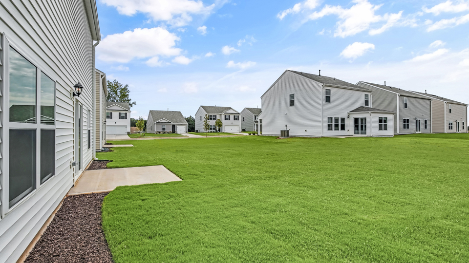 exterior patio with concrete slab and open yard