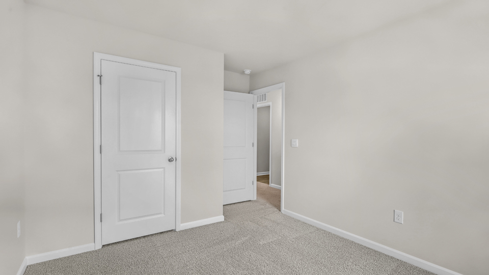 additional bedroom with window, carpeting, closet