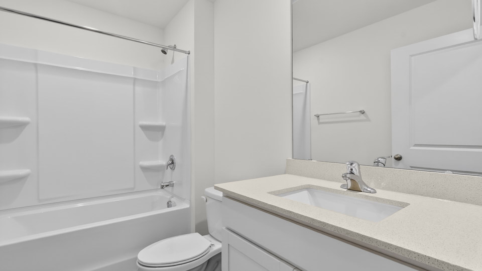 secondary bathroom with shower tub combo and single vanity sink