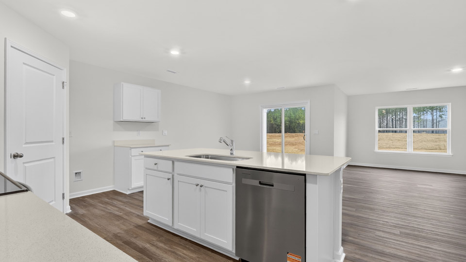 kitchen with quartz counters, kitchen island, pantry, stainless steel appliances