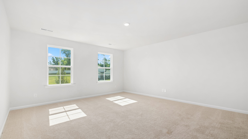 Primary bedroom with carpet flooring