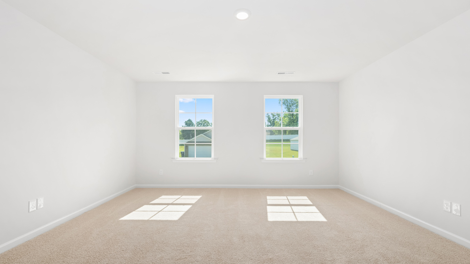 Primary bedroom with carpet flooring
