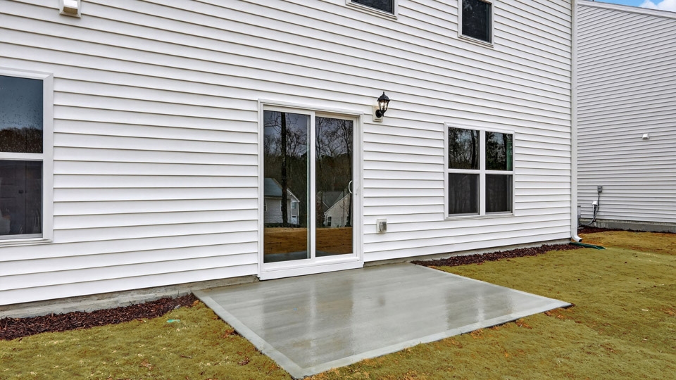 back of penwell with uncovered concrete patio