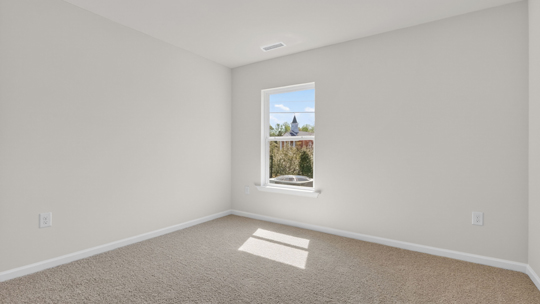 secondary bedroom with window and closet, carpeting