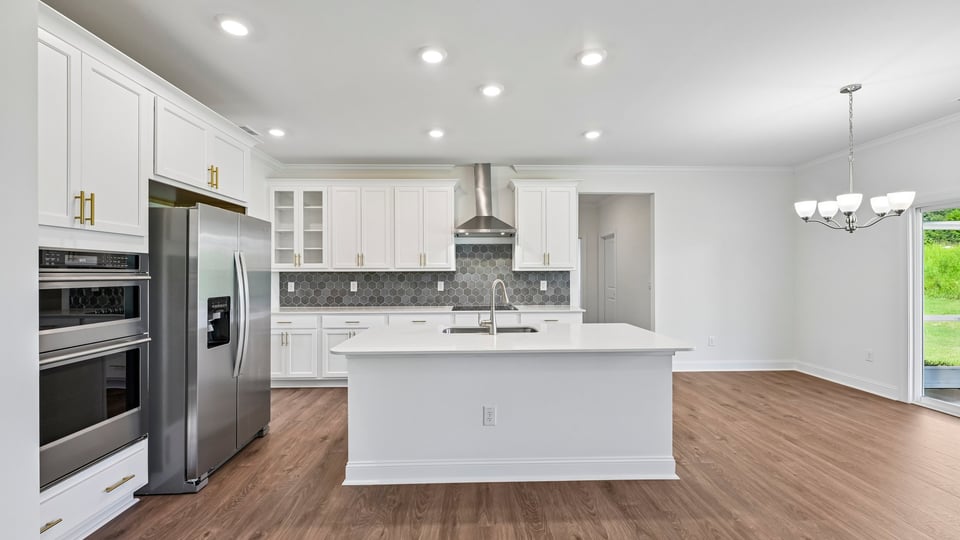kitchen with spacious island white cabinets and quartz countertops