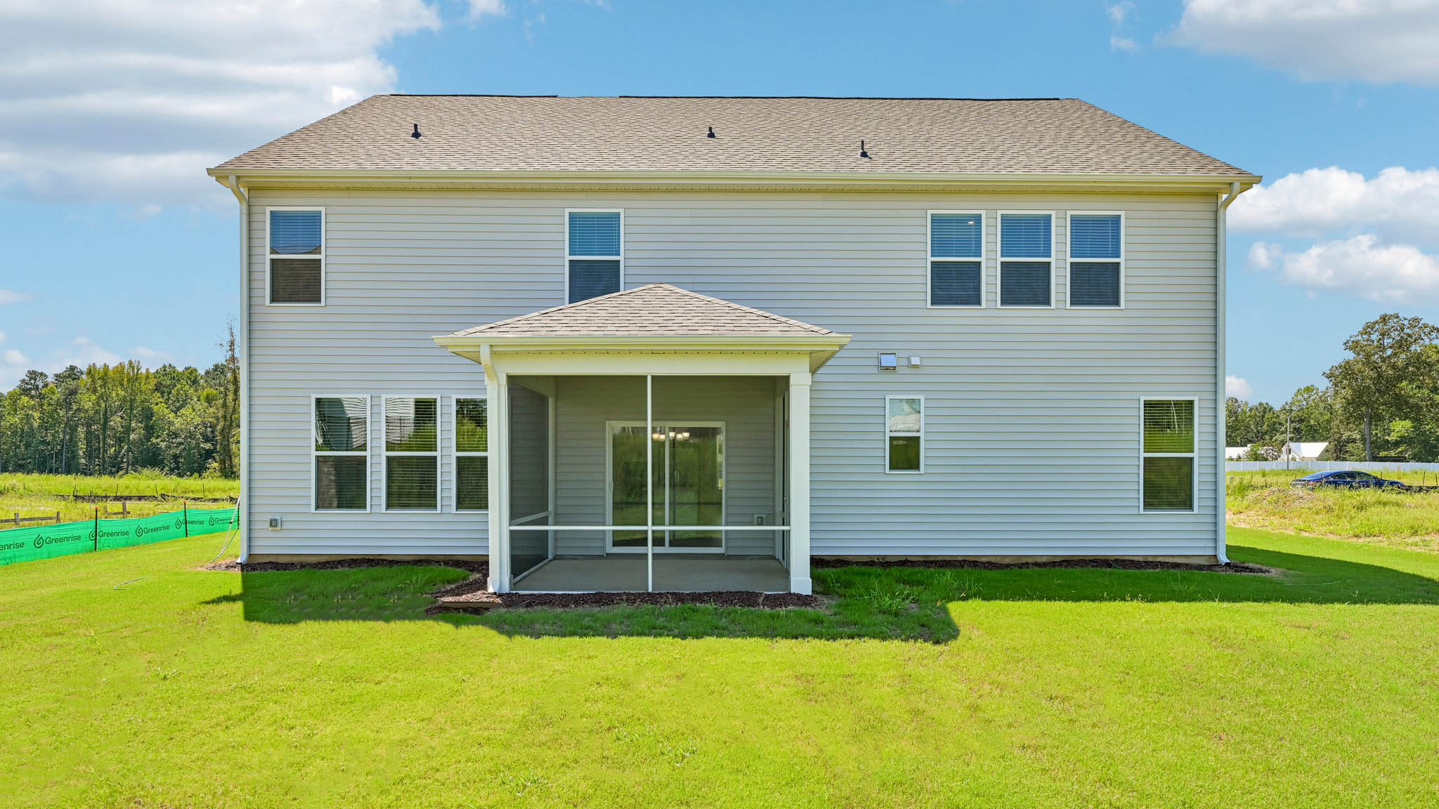 back of home with covered and screened back patio