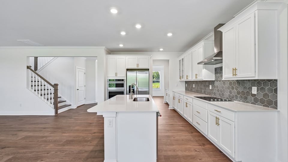 kitchen with white cabinets spacious island and quartz countertops