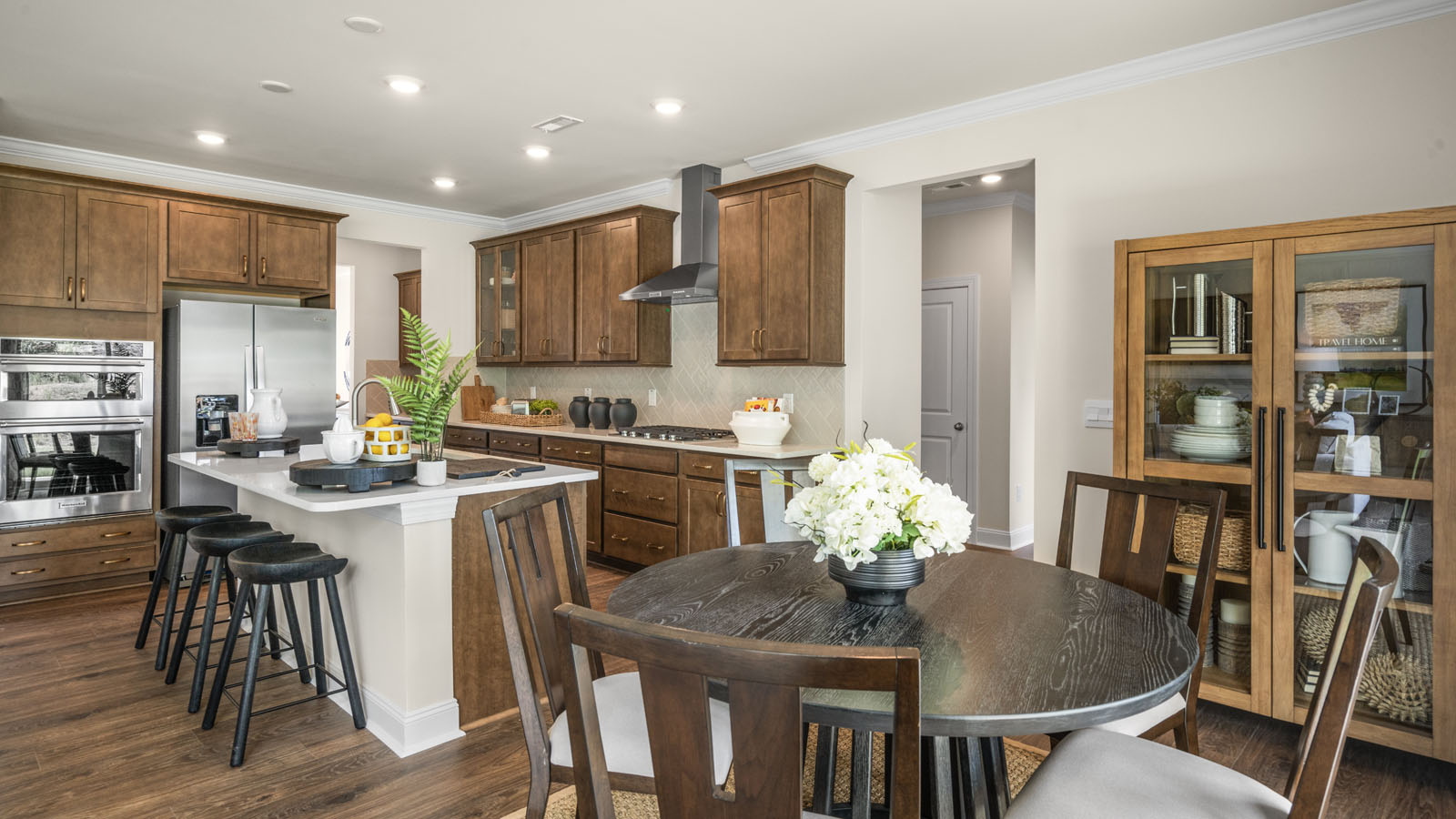 kitchen with quartz counters, kitchen island, pantry, stainless steel appliances