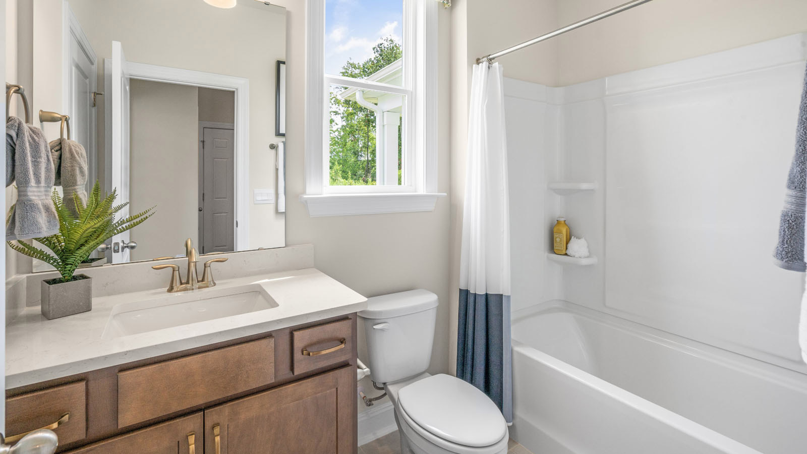 secondary bathroom with shower tub combo and single vanity sink