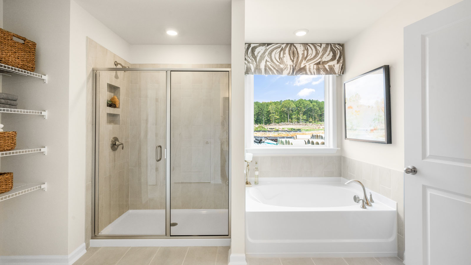 primary bathroom with walk in shower, bathtub, and dual vanity sinks