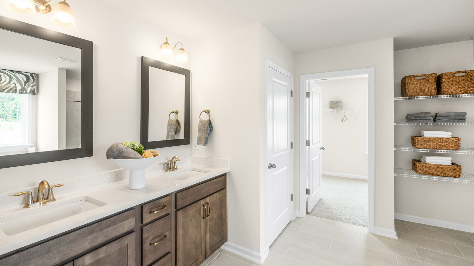 primary bathroom with walk in shower, bathtub, and dual vanity sinks