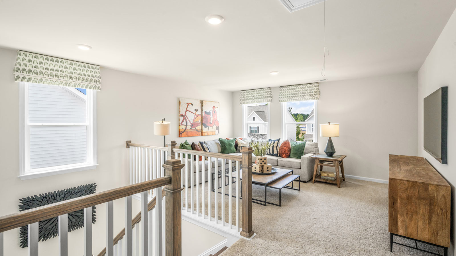 upstairs loft area with large windows and carpeting